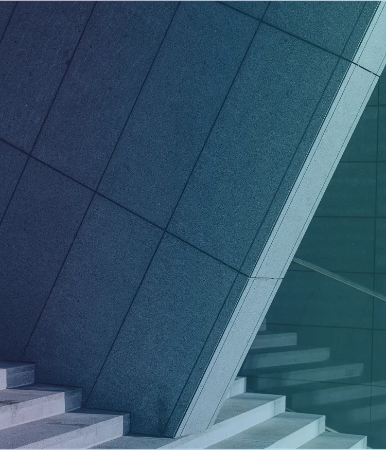 Detailaufnahme einer einer Treppe und einer massiv wirkenden Betonstruktur.