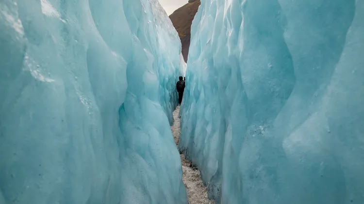 A narrow path running between two towering ice walls.