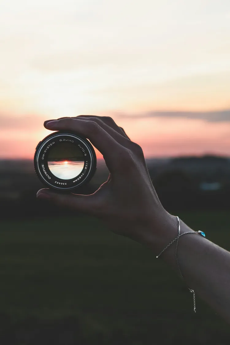 Unsplash image for hands together over wooden table warm light